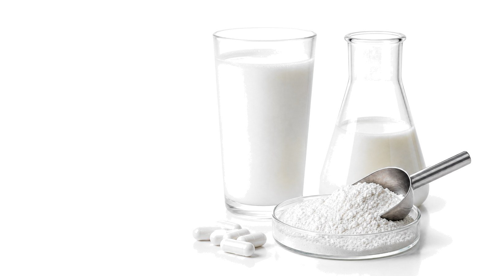A small glass dish of fine white protein powder beside a laboratory flask on a bright white studio background