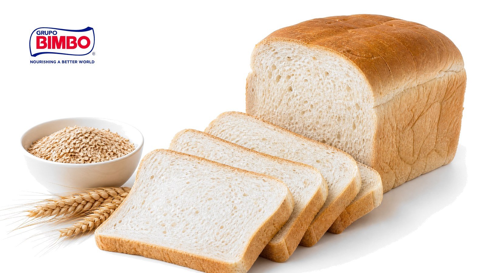 A sliced white sandwich loaf with fanned slices, a bowl of wheat bran and a sprig of wheat on white, with the Grupo Bimbo logo