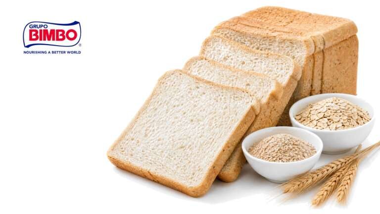 Bright studio photo of a loaf of packaged white sandwich bread with a few slices fanned out on a pure white background