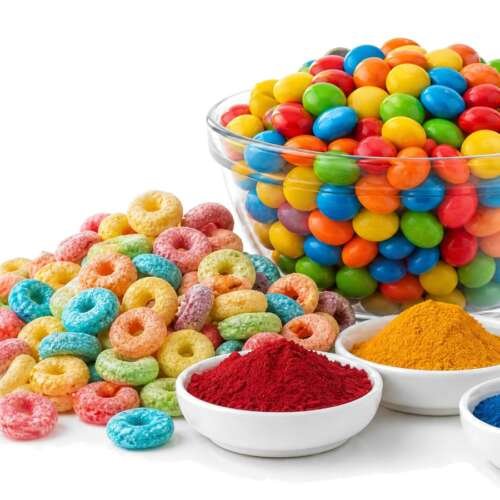 Naturally colored breakfast cereal loops in a white bowl on a pure white studio background