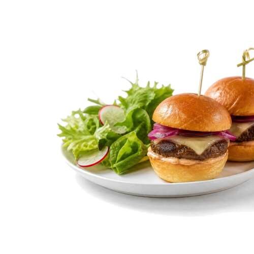 Two slider burgers and a side salad on a white plate beside a small pink cocktail