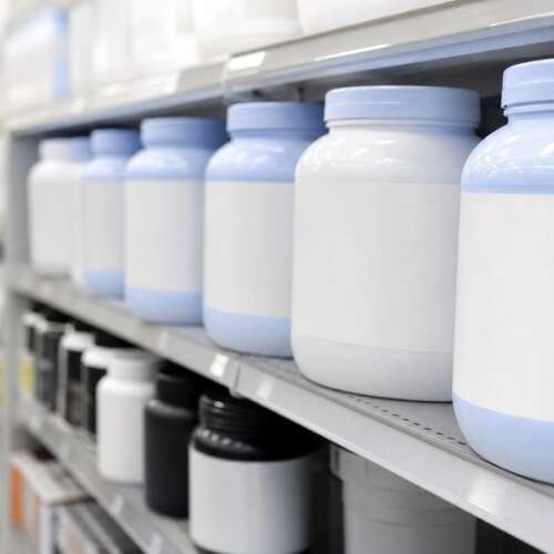 A pharmacy shelf lined with plain unlabeled tubs of protein nutrition powder