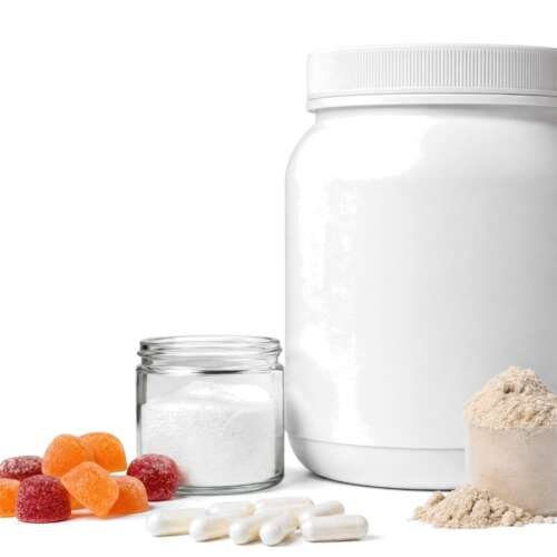 A tub of protein powder with a scoop, fiber gummies, probiotic capsules and a jar of collagen powder on white