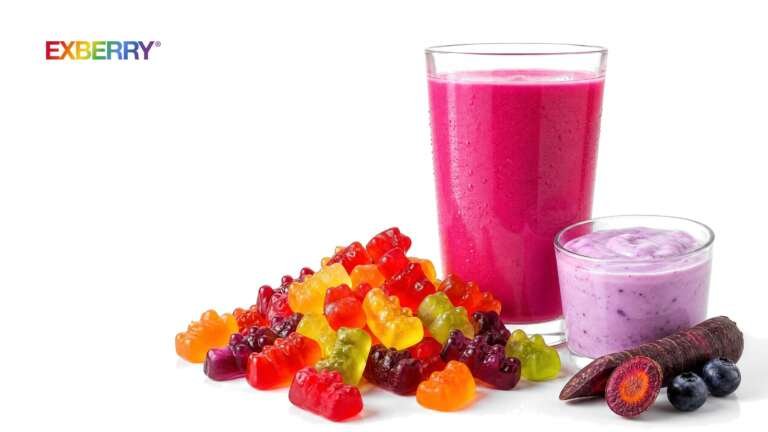 A pink fruit drink, colorful gummy candies and lavender yogurt with a purple carrot and blueberries, with the EXBERRY logo