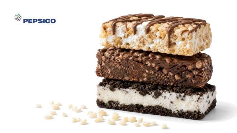 A stack of three protein bars, marshmallow crisp, brownie crisp and cookies and cream, on white, with the PepsiCo logo