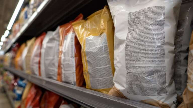 Supermarket shelf of packaged snacks turned to show their ingredient panels