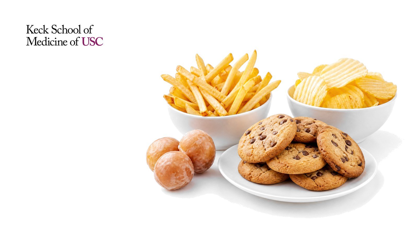 A plate of chocolate chip cookies, a bowl of French fries, a bowl of potato chips and glazed donut holes on white, with the Keck School of Medicine of USC logo