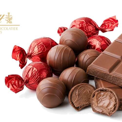 Red Lindt Lindor milk chocolate truffle bag and a gold-wrapped Lindt Excellence bar on a bright pure white studio background