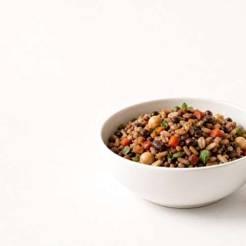 Bowl of rice, lentils, chickpeas and vegetables beside a jar of oats and dark chocolate, with the Mars logo