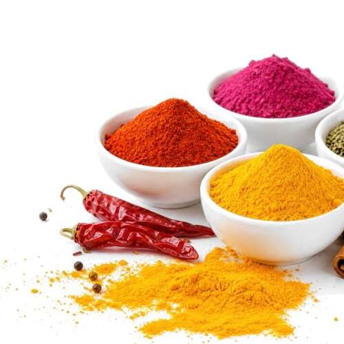 Bowls of paprika, turmeric, beet powder and herbs with dried chilies and cinnamon on white, with the McCormick logo