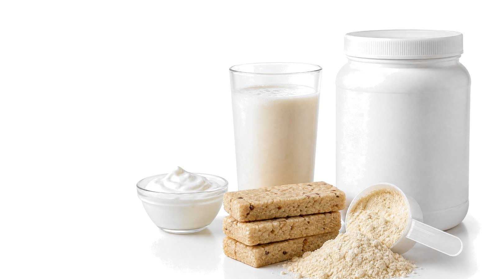 A tub of protein powder with a spilled scoop, protein bars, a protein shake and a bowl of yogurt on white