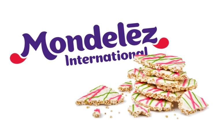 Crispy quinoa pieces with white frosting and pink and green drizzle in front of a large Mondelez International logo on white