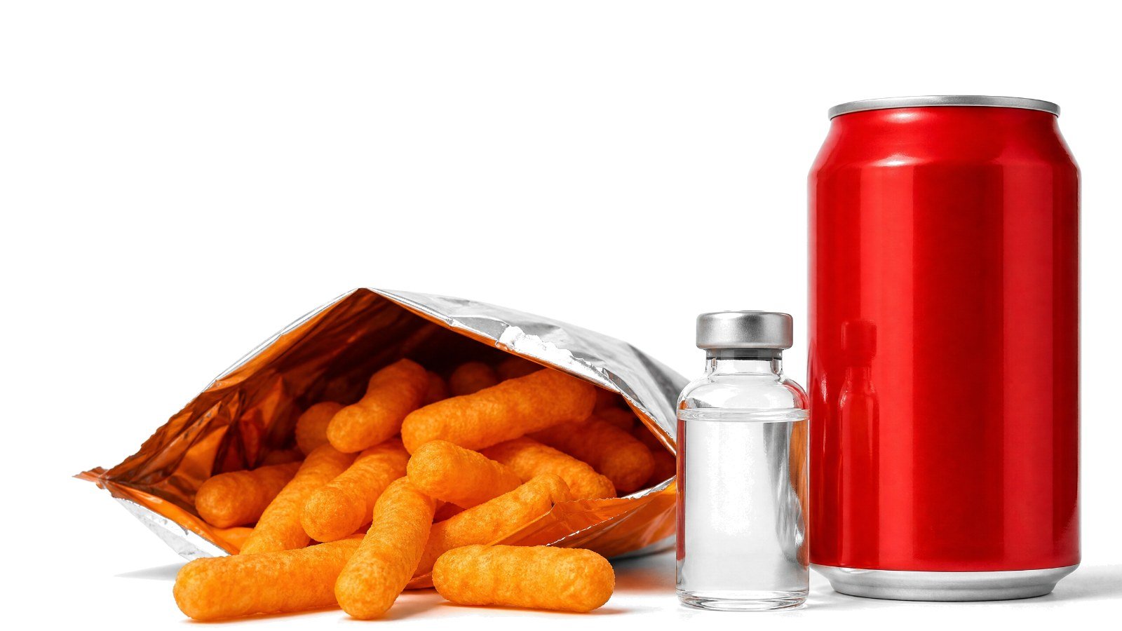 A small unlabeled vaccine vial between an open bag of cheese puffs and a red soda can